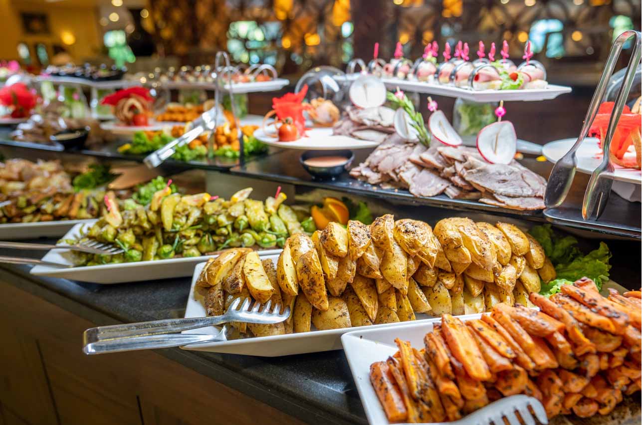 Close up of foods with plates in buffet of restaurant. 